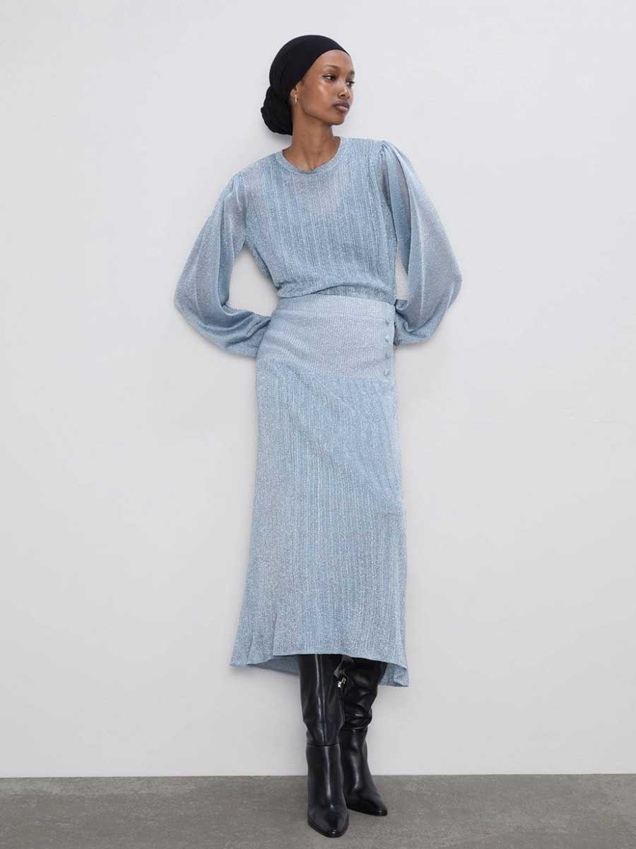 Loewe fall 2023 ready-to-wear collection featuring an oversized long grey cardigan sweater and midi skirt set