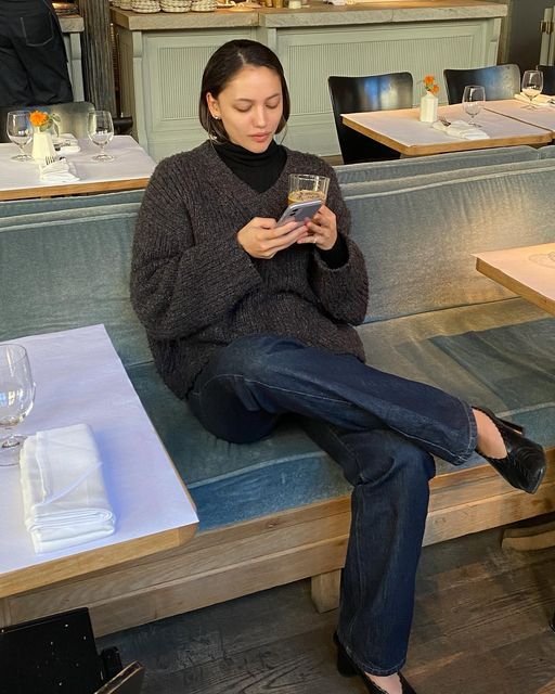 Classy fall outfit with brown sweater, black turtleneck, denim jeans and kitten heels