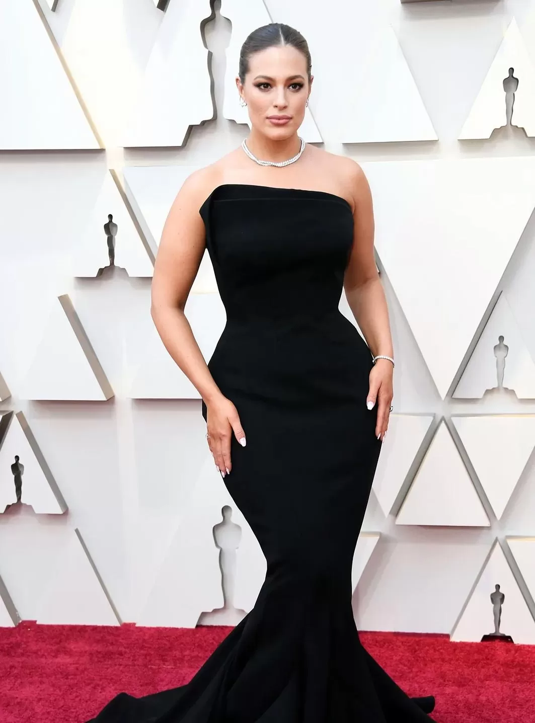 Ashley Graham in black hourglass dress at the Oscars red carpet