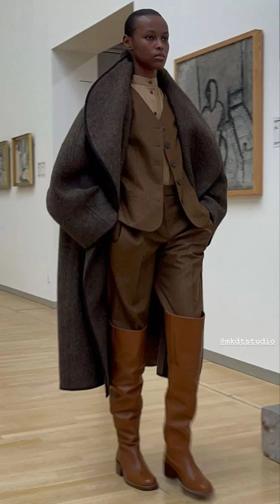 Expensive looking outfits - layered brown vest with brown trousers, brown tall boots, and a brown coat