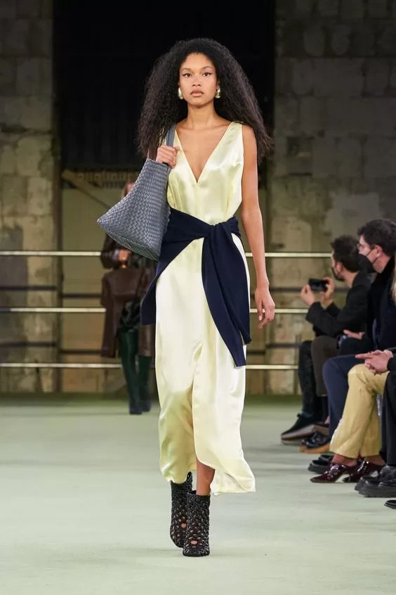 Silk maxi dress with sweater tied around waist from Bottega Veneta Fall Ready to Wear 2022